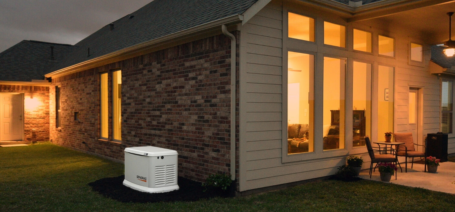 generator beside brick house at night