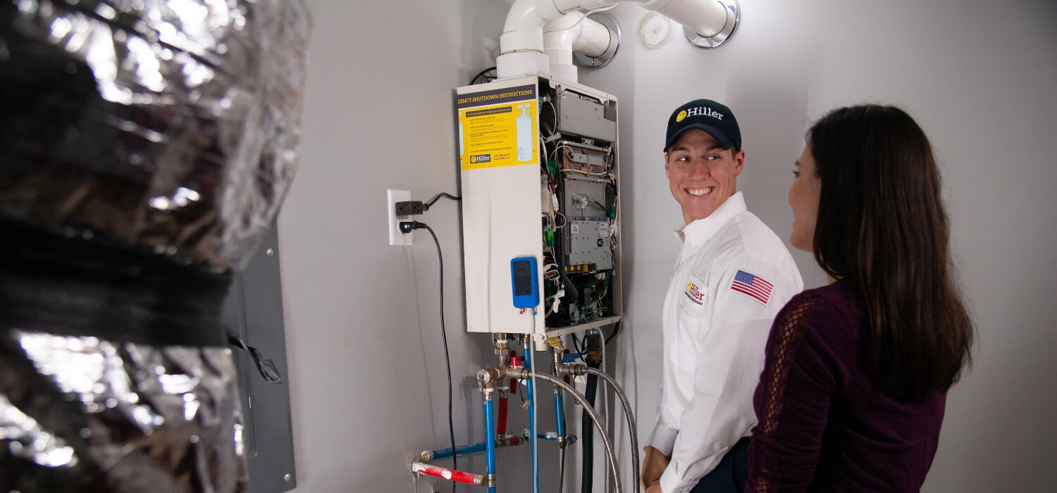 technician repairs tankless water heater