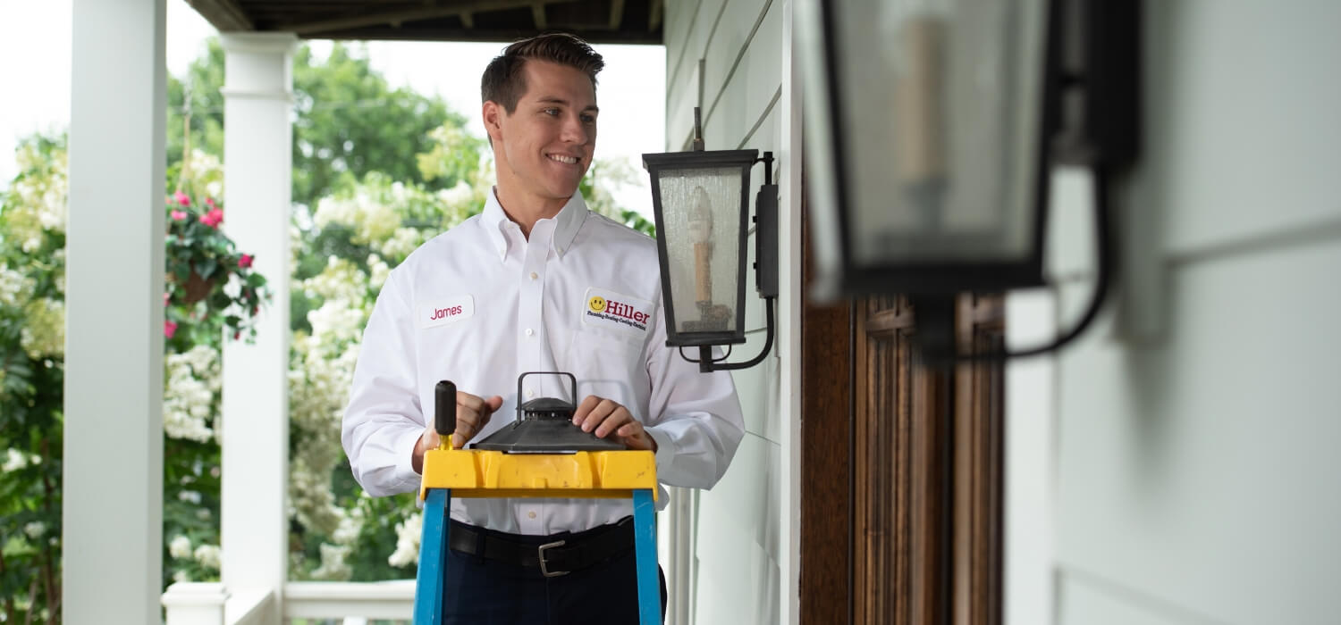 technician fixing outdoor light