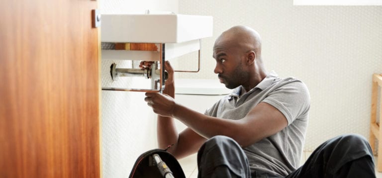 man fixing basic plumbing