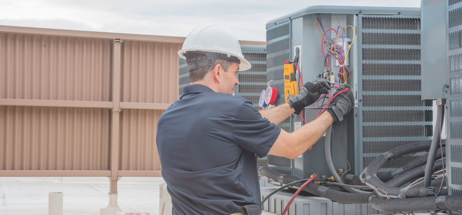 technician working on noisy air conditioner