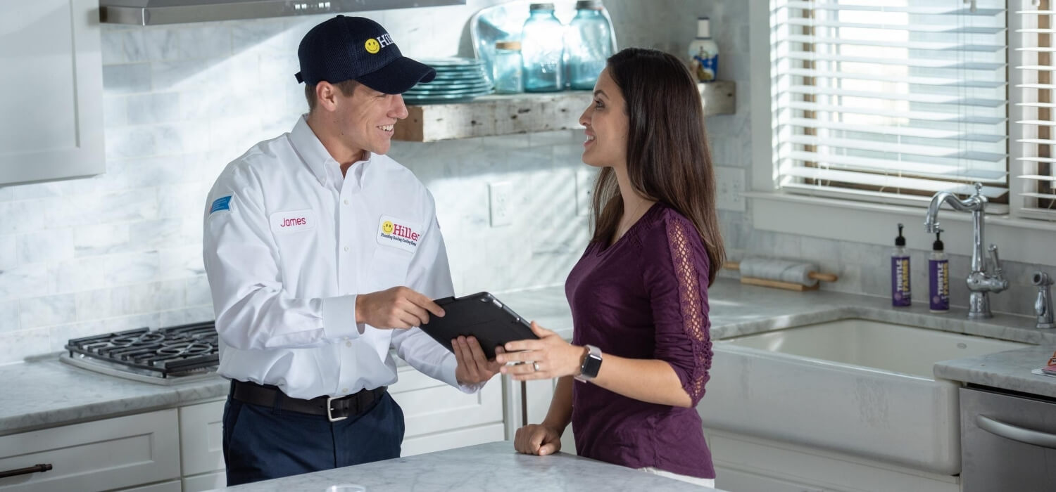 technician talking to customer about hvac replacement