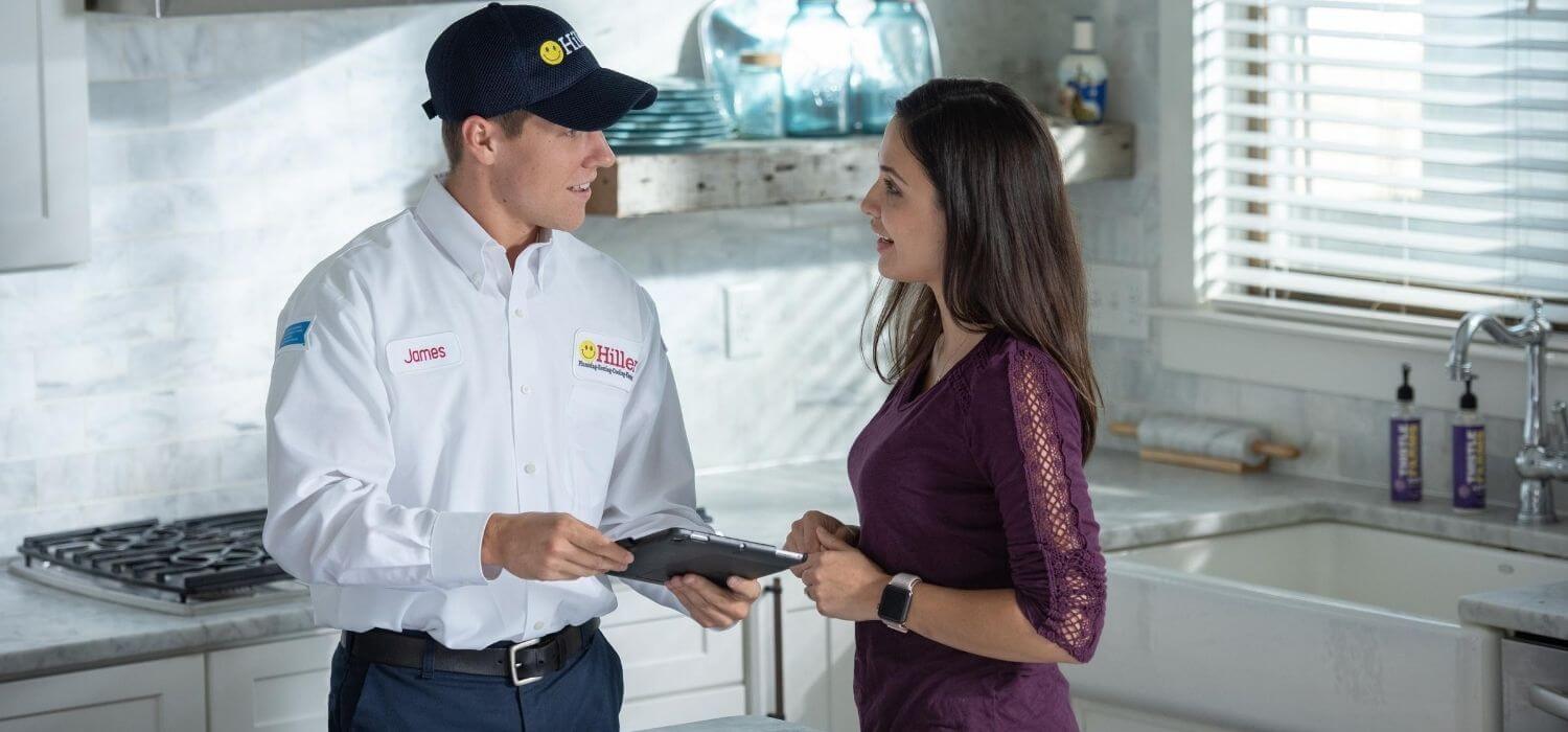 technician explaining electric water heater tips