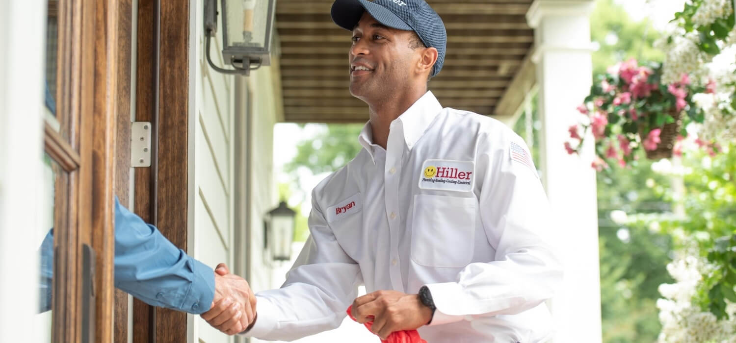 Hiller technician greeting homeowner