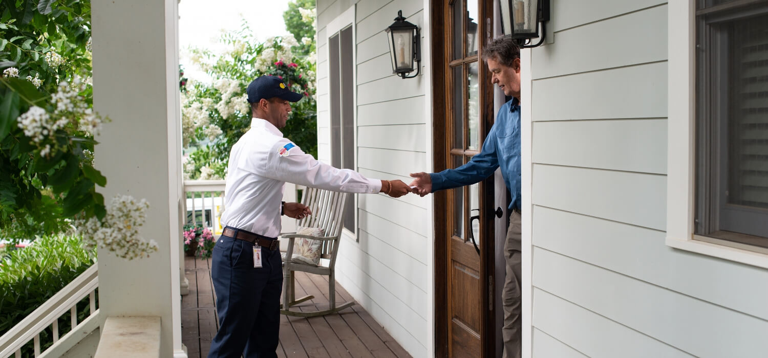 technician greeting customer with business card