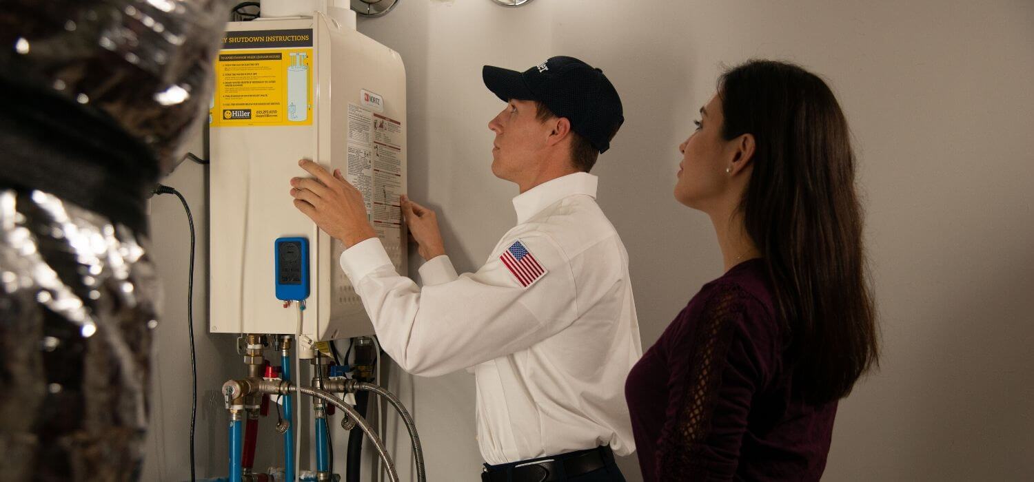 tech showing customer tankless water heater