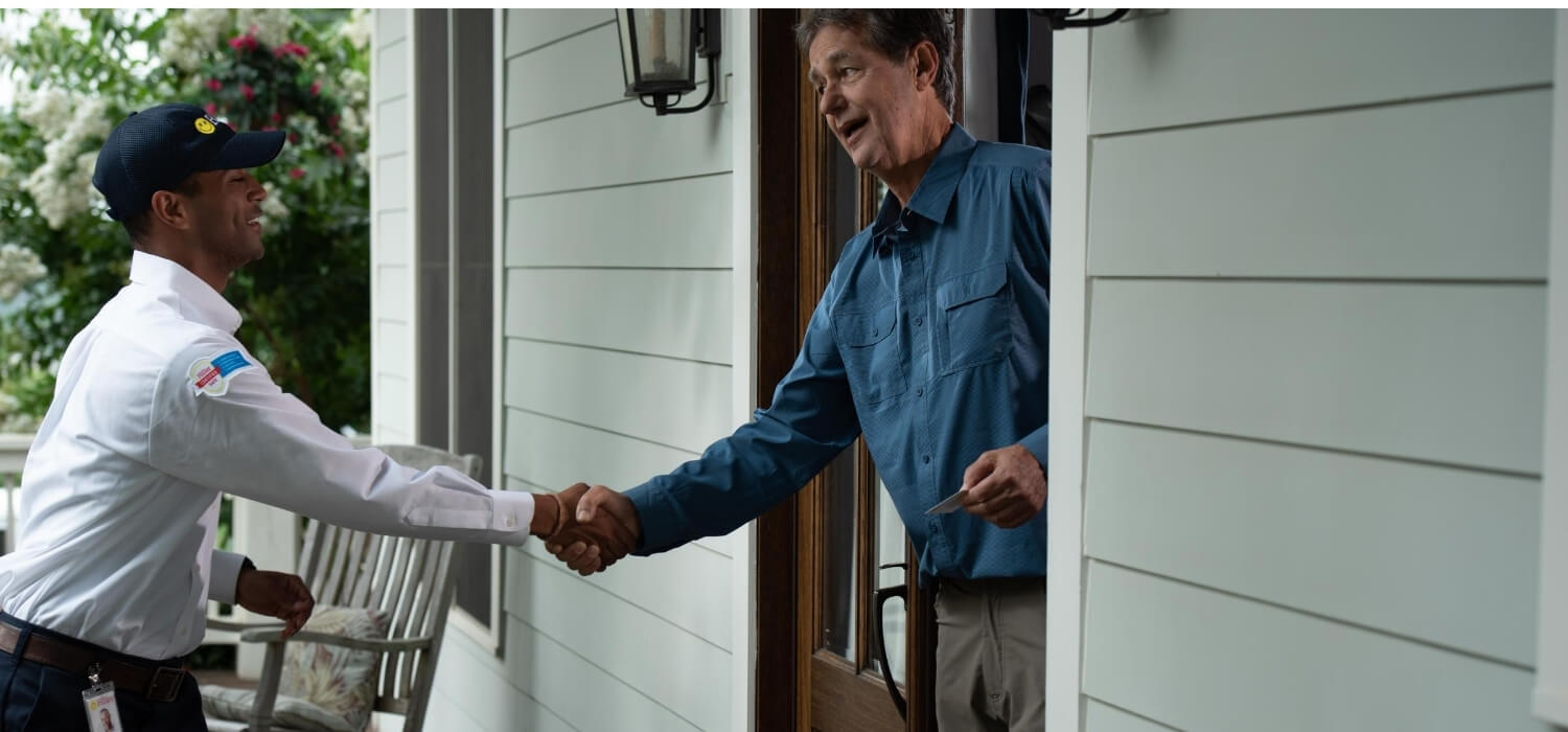 homeowner greeting technician for home upgrade