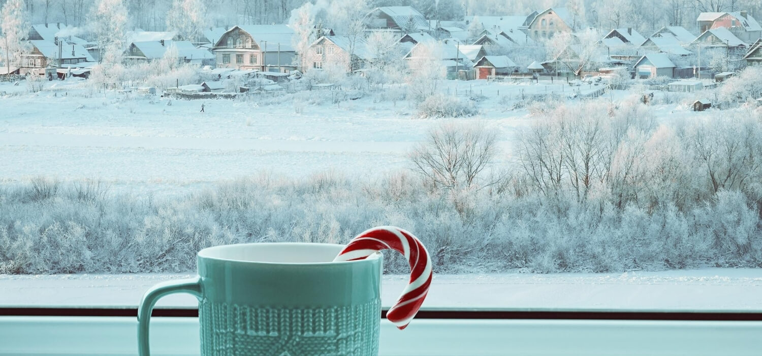 hot drink at window with snow in background