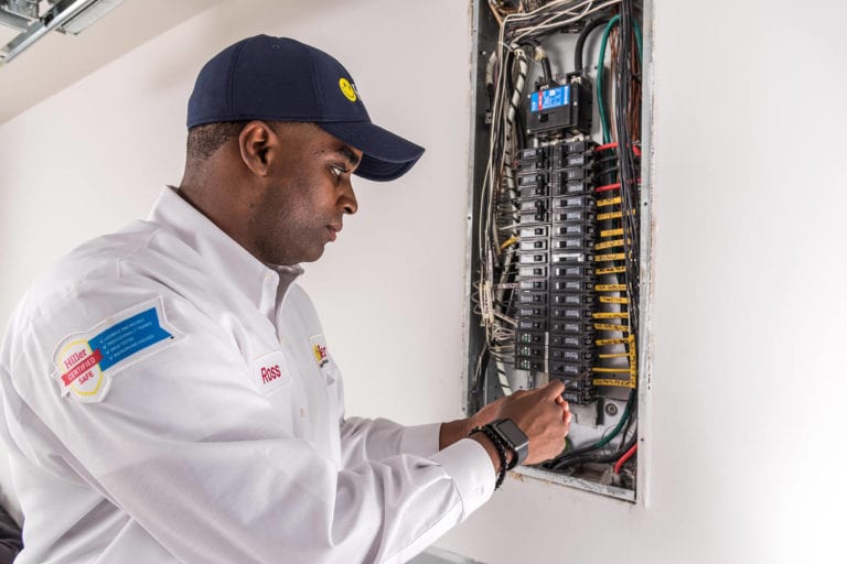 Electrician working on electrical panel