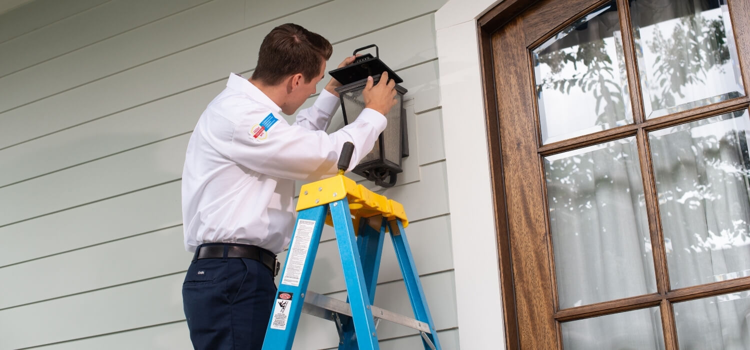 Electrician Fixing Outdoor Flickering Light