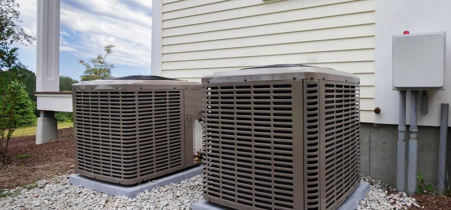 Two HVAC Units Outside on Gravel