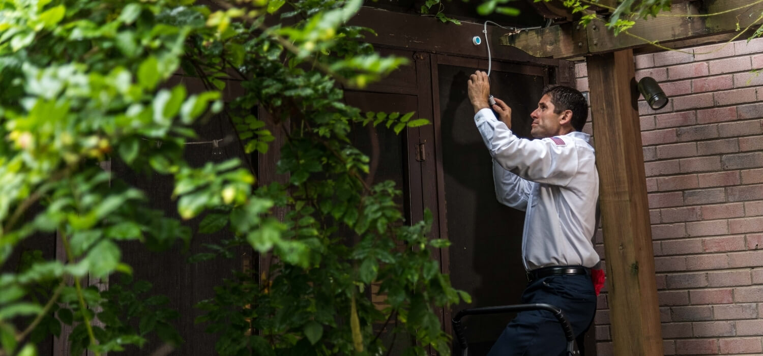 Hiller Electrician Fixing Outside Wires To A Camera