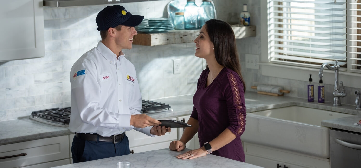 Hiller HVAC Technician Explaining Fix or Replacement Options to Homeowner