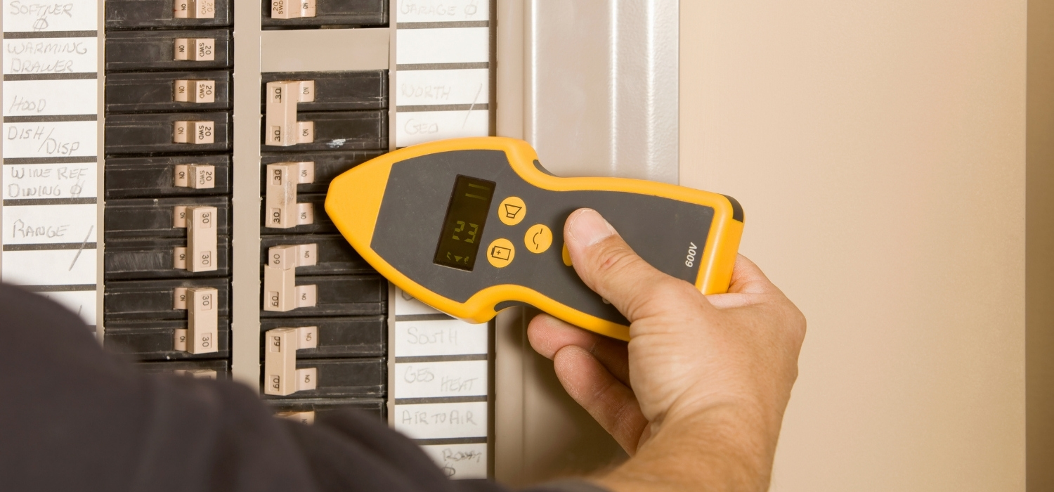 Electrician Using Circuit Tracer Receiver on Breaker Panel