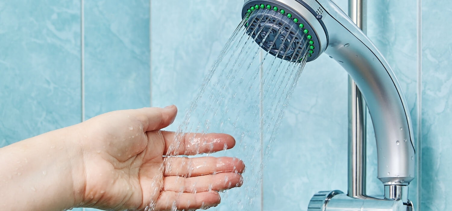 Hand Feeling the Temperature of the Water in the Shower