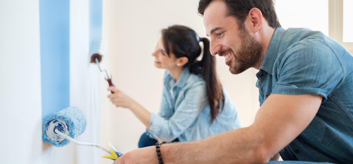 Couple Renovating Room by Painting