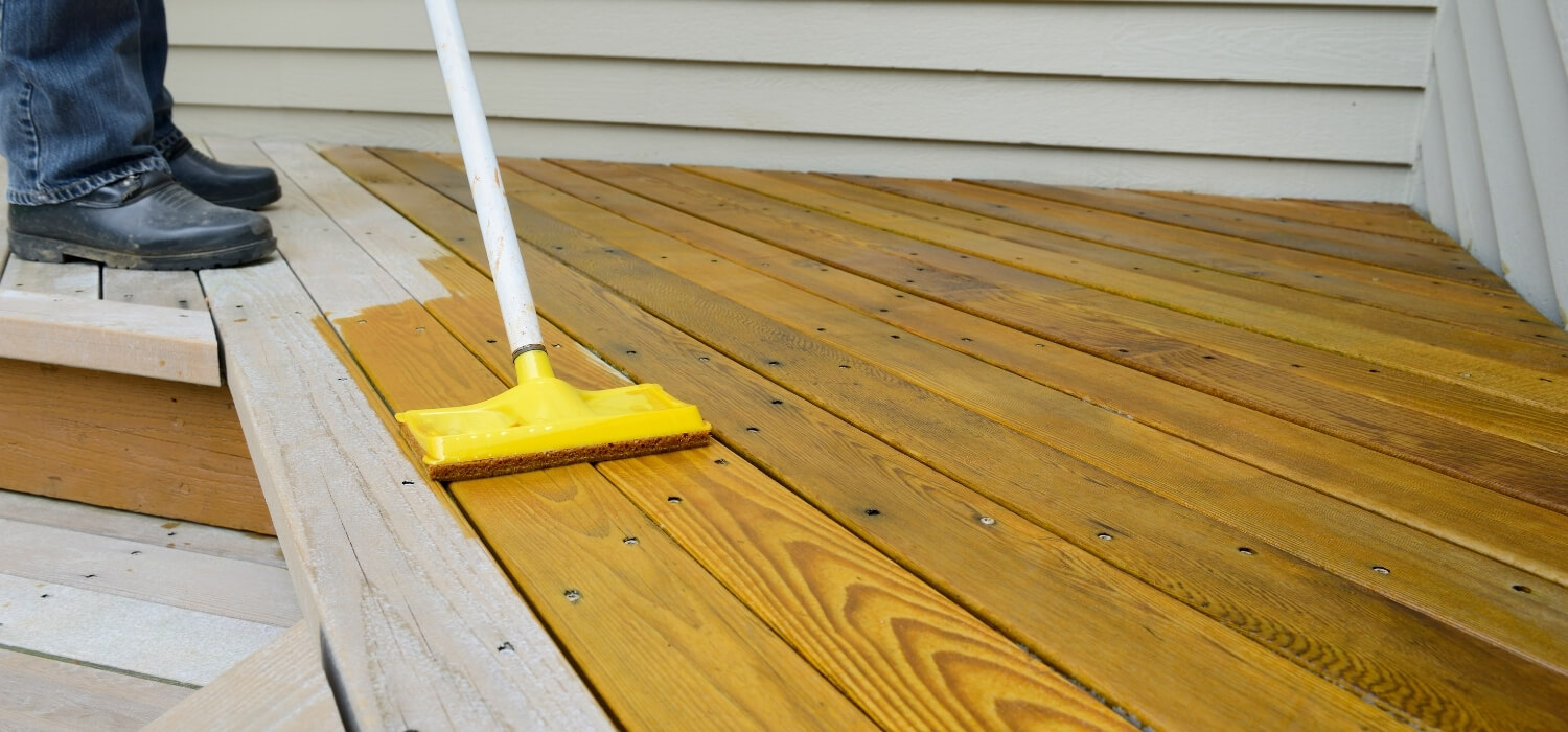 Homeowner Staining their Renovated Deck