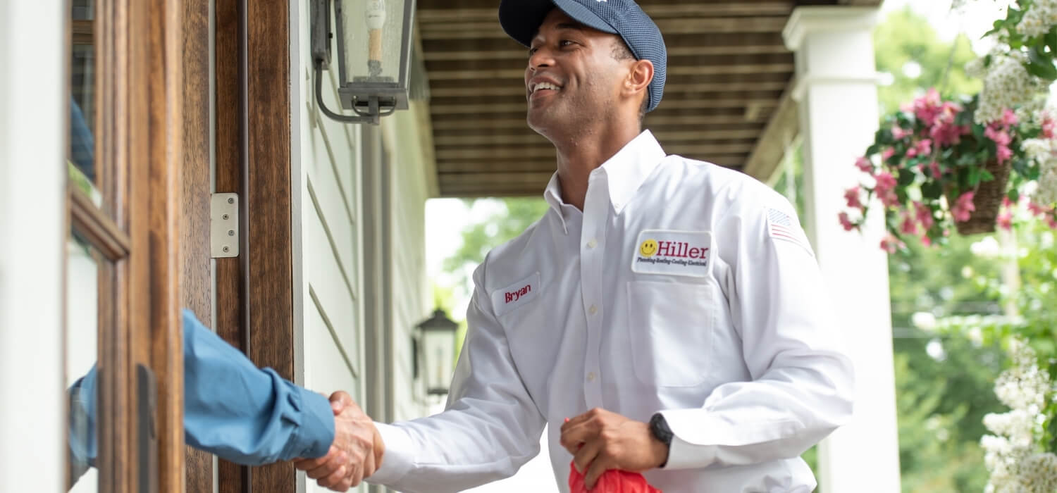 Hiller Technician Greeting Homeowner for Gas Furnace Maintenance