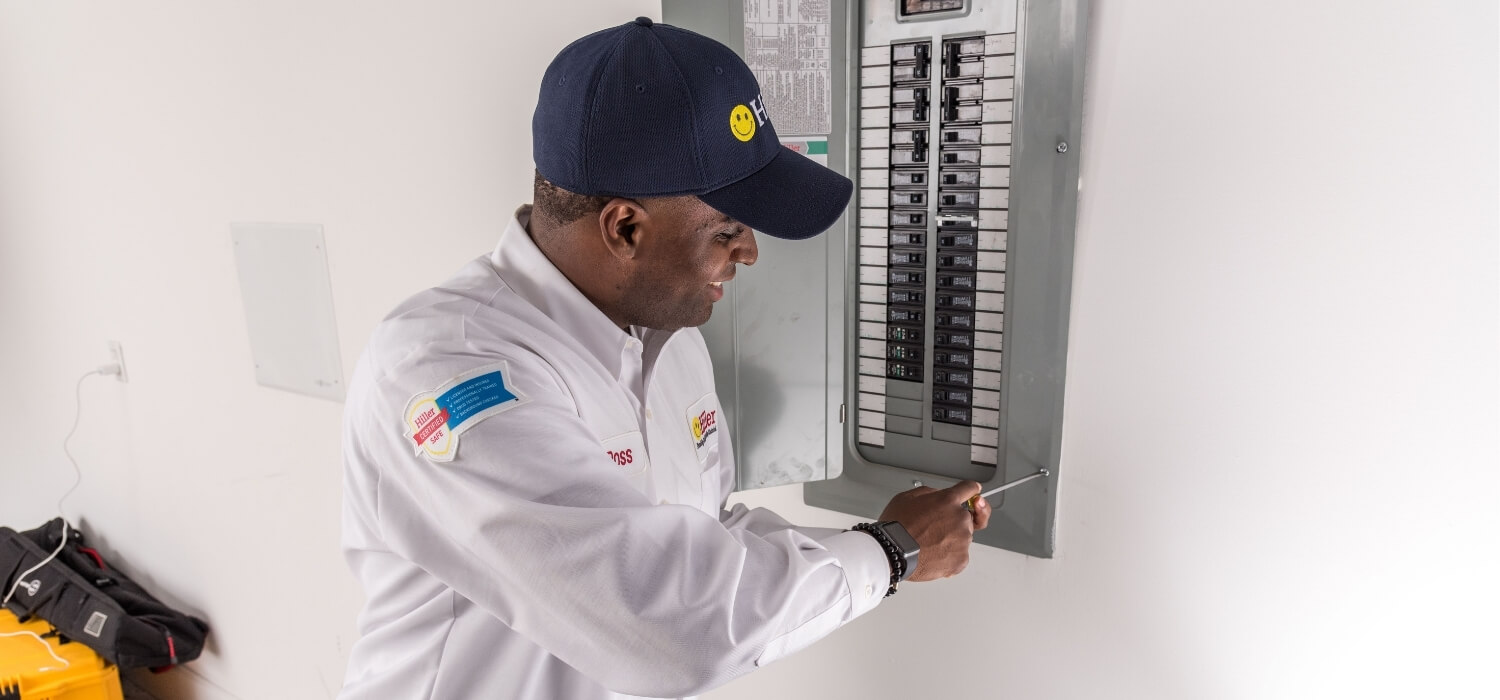 Electrician Working on Circuit Breaker