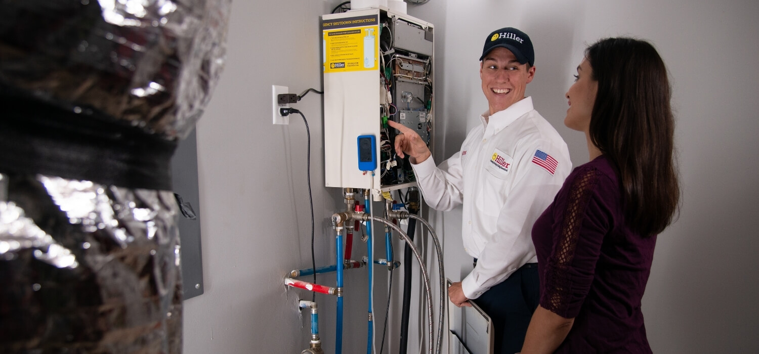 Plumber Performing Maintenance on the Tankless Water Heater