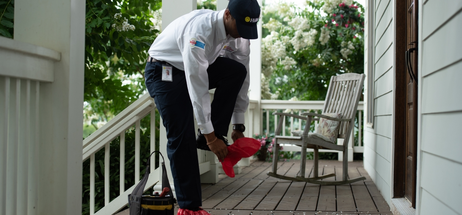 Plumber Putting on Floor Savers Before Entering a Home