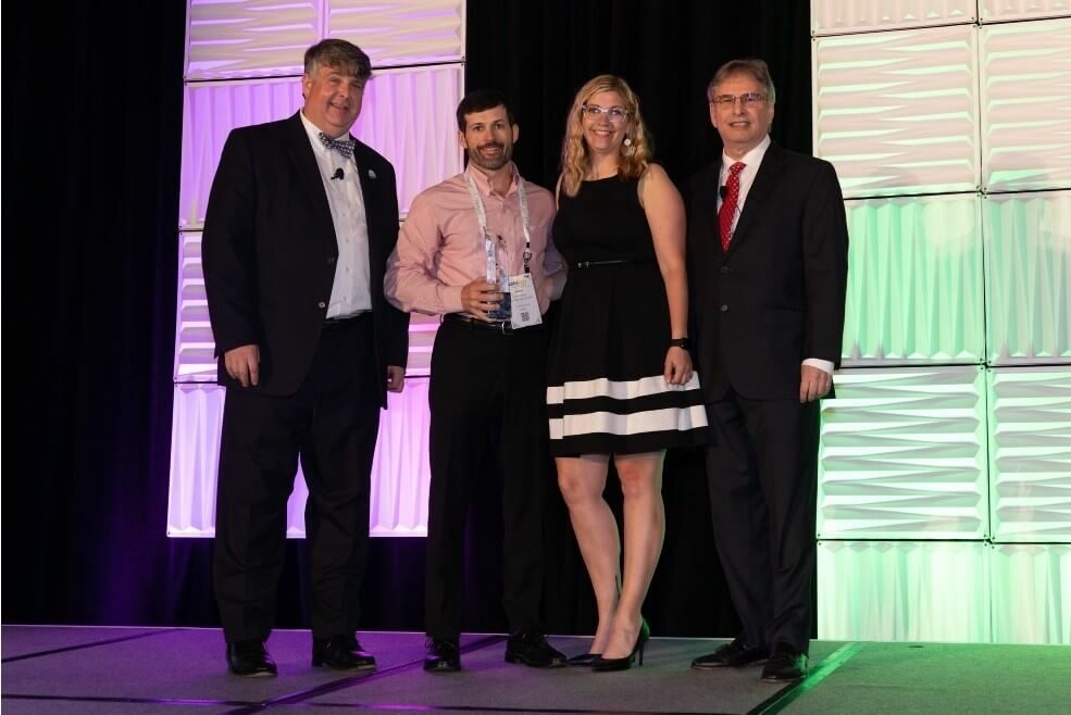 Jimmy Hiller, Jr. and Megan Manning accepting Hiller's award from ACCA representatives.