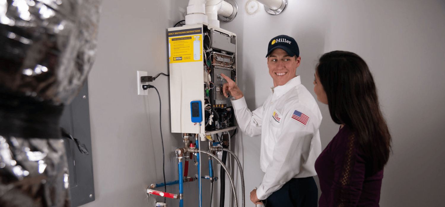 Technician Reviewing Tankless Water Heater with Woman