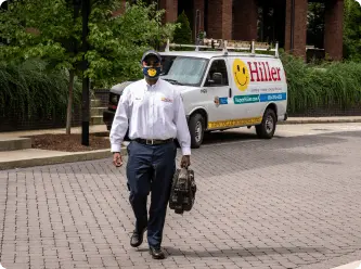 Technician walking with tools near service van